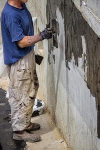 Waterproofing contractor sealing foundation wall, Huff Insurance, Pasadena Maryland
